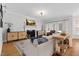 Bright living room features stylish furnishings, hardwood floors, and a fireplace with mantle and cabinetry at 1113 Colonial Club Road Rd, Wake Forest, NC 27587