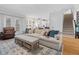 Open living area with plush seating, hardwood floors, and easy access to the kitchen and staircase at 1113 Colonial Club Road Rd, Wake Forest, NC 27587