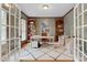 Stylish home office featuring built-in bookshelves, a modern desk, and a cozy seating area at 1113 Colonial Club Road Rd, Wake Forest, NC 27587