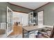 Comfortable home office with a spacious desk, hardwood floors, and access to a formal dining area at 1113 Colonial Club Road Rd, Wake Forest, NC 27587