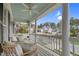 Inviting porch with white pillars and ceiling fan; features comfortable seating and neighborhood views at 1113 Colonial Club Road Rd, Wake Forest, NC 27587
