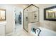 Well lit bathroom showcasing a glass enclosed shower and separate tub with tile surround at 1114 Glenolden Ct, Cary, NC 27513