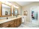 Bathroom with double sinks, granite countertop, and well-organized walk-in closet at 1114 Glenolden Ct, Cary, NC 27513