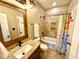 Well lit bathroom with a tub-shower combo and granite sink vanity at 1114 Glenolden Ct, Cary, NC 27513