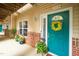 Charming entrance with teal door, decorative wreath, and well-placed planters at 1114 Glenolden Ct, Cary, NC 27513