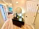 Hallway with a dark wood table, mirror, wooden floors, and a glimpse of the brightly painted living room at 1114 Glenolden Ct, Cary, NC 27513