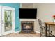 Inviting living room with a cozy fireplace and mounted flat screen tv at 1114 Glenolden Ct, Cary, NC 27513