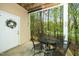Covered patio with metal patio set overlooking a wooded area at 1114 Glenolden Ct, Cary, NC 27513