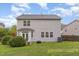 Backyard view features a well-maintained lawn, a patio area, and tidy landscaping at 112 Mendells Dr, Holly Springs, NC 27540
