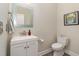 Elegant bathroom with a modern vanity, framed mirror, and a toilet offers a clean and stylish space at 112 Mendells Dr, Holly Springs, NC 27540