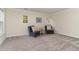Inviting bedroom area with plush carpet, two cozy chairs, and ample natural light from the windows at 112 Mendells Dr, Holly Springs, NC 27540