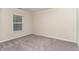 Comfortable bedroom with plush carpet, a window letting in natural light, and a cozy ambiance at 112 Mendells Dr, Holly Springs, NC 27540