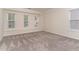 Spacious bedroom with soft carpet and ample natural light from multiple windows creates a welcoming atmosphere at 112 Mendells Dr, Holly Springs, NC 27540