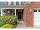 Charming brick facade with a welcoming front door and meticulously maintained landscaping at 112 Mendells Dr, Holly Springs, NC 27540