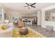 Open floor plan showcasing the living room with hardwood floors, lots of natural light, and seamless flow to the kitchen at 112 Mendells Dr, Holly Springs, NC 27540