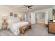 Bright primary bedroom with cozy furniture, soft carpet, and neutral tones creates a peaceful atmosphere at 112 Mendells Dr, Holly Springs, NC 27540