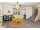 Bright playroom with hardwood floors, modern furnishings, and access to the living area and staircase at 112 Mendells Dr, Holly Springs, NC 27540