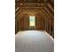 Unfinished attic with exposed wood beams and window, offering potential for customization at 112 Surles Landing Way, Benson, NC 27504