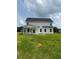 Backyard view of a two-story home with a covered porch, lawn, and vinyl siding at 112 Surles Landing Way, Benson, NC 27504