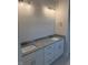 Bright bathroom featuring double sinks, granite countertops, and modern lighting fixtures at 112 Surles Landing Way, Benson, NC 27504