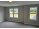 Bedroom with two windows and neutral-toned walls and carpet at 112 Surles Landing Way, Benson, NC 27504