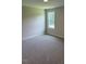 Bright bedroom featuring plush carpeting, neutral walls, and a window with a natural view at 112 Surles Landing Way, Benson, NC 27504