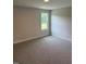 Bedroom with one window and neutral-toned walls and carpet at 112 Surles Landing Way, Benson, NC 27504