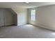 Spacious carpeted bedroom has a window with outside view and a white interior door at 112 Surles Landing Way, Benson, NC 27504