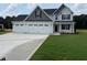 Charming two-story home with a three car garage, manicured lawn and inviting curb appeal at 112 Surles Landing Way, Benson, NC 27504