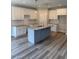 Open kitchen featuring an island, granite countertops and white cabinetry at 112 Surles Landing Way, Benson, NC 27504