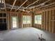 Unfinished living room featuring a doorway, two windows, and ceiling beams and ductwork at 112 Surles Landing Way, Benson, NC 27504