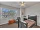 Bright bedroom with large window, ceiling fan, and comfortable bed is bathed in natural light at 115 Windy Creek Ln, Apex, NC 27502