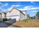 Bright white siding and a two-car garage highlight this attractive townhome at 115 Windy Creek Ln, Apex, NC 27502