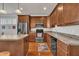 Well-equipped kitchen with stainless steel appliances and wood cabinets at 115 Windy Creek Ln, Apex, NC 27502