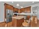 Spacious kitchen with stainless steel appliances, wood cabinets, and a center island at 115 Windy Creek Ln, Apex, NC 27502