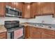 Functional kitchen featuring stainless steel appliances, and wood cabinets at 115 Windy Creek Ln, Apex, NC 27502