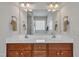 Spacious bathroom featuring double sinks, cherry cabinets and granite countertop with great lighting at 115 Windy Creek Ln, Apex, NC 27502