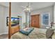 Comfortable main bedroom includes ceiling fan and media center with natural light creating inviting space at 115 Windy Creek Ln, Apex, NC 27502