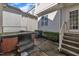 Private back patio with hot tub features steps to backdoor and a partially fenced yard at 115 Windy Creek Ln, Apex, NC 27502