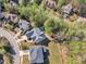 Wide aerial shot of the neighborhood showcasing mature trees and the home with a private backyard pool at 116 Palermo Ct, Apex, NC 27539