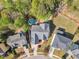 Aerial view of a private backyard featuring an in-ground pool and outdoor living space with mature trees at 116 Palermo Ct, Apex, NC 27539