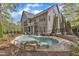 Expansive backyard with a pool, patio, lush landscaping, and multiple outdoor seating areas at 116 Palermo Ct, Apex, NC 27539
