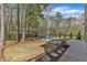 Lush backyard featuring a spacious lawn, fire pit, swing set, and a deck for outdoor living at 116 Palermo Ct, Apex, NC 27539