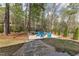 Landscaped backyard featuring a fire pit with Adirondack chairs and a swing set for leisure and relaxation at 116 Palermo Ct, Apex, NC 27539