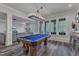 Finished basement area with a pool table, a large picture window, and a seating area at 116 Palermo Ct, Apex, NC 27539