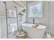 Inviting bathroom features a soaking tub, decorative window, and ladder shelving adding style and function at 116 Palermo Ct, Apex, NC 27539