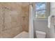 Comfortable bathroom with tile backsplash, tub/shower and window at 116 Palermo Ct, Apex, NC 27539