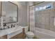 Well-lit bathroom featuring a tub/shower combo, vanity with undermount sink, and neutral tile work at 116 Palermo Ct, Apex, NC 27539