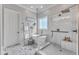 Bathroom with a modern soaking tub, glass-enclosed shower, and decorative marble tile flooring at 116 Palermo Ct, Apex, NC 27539
