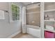 Bright bathroom featuring a bathtub, a shower, and built-in shelving at 116 Palermo Ct, Apex, NC 27539